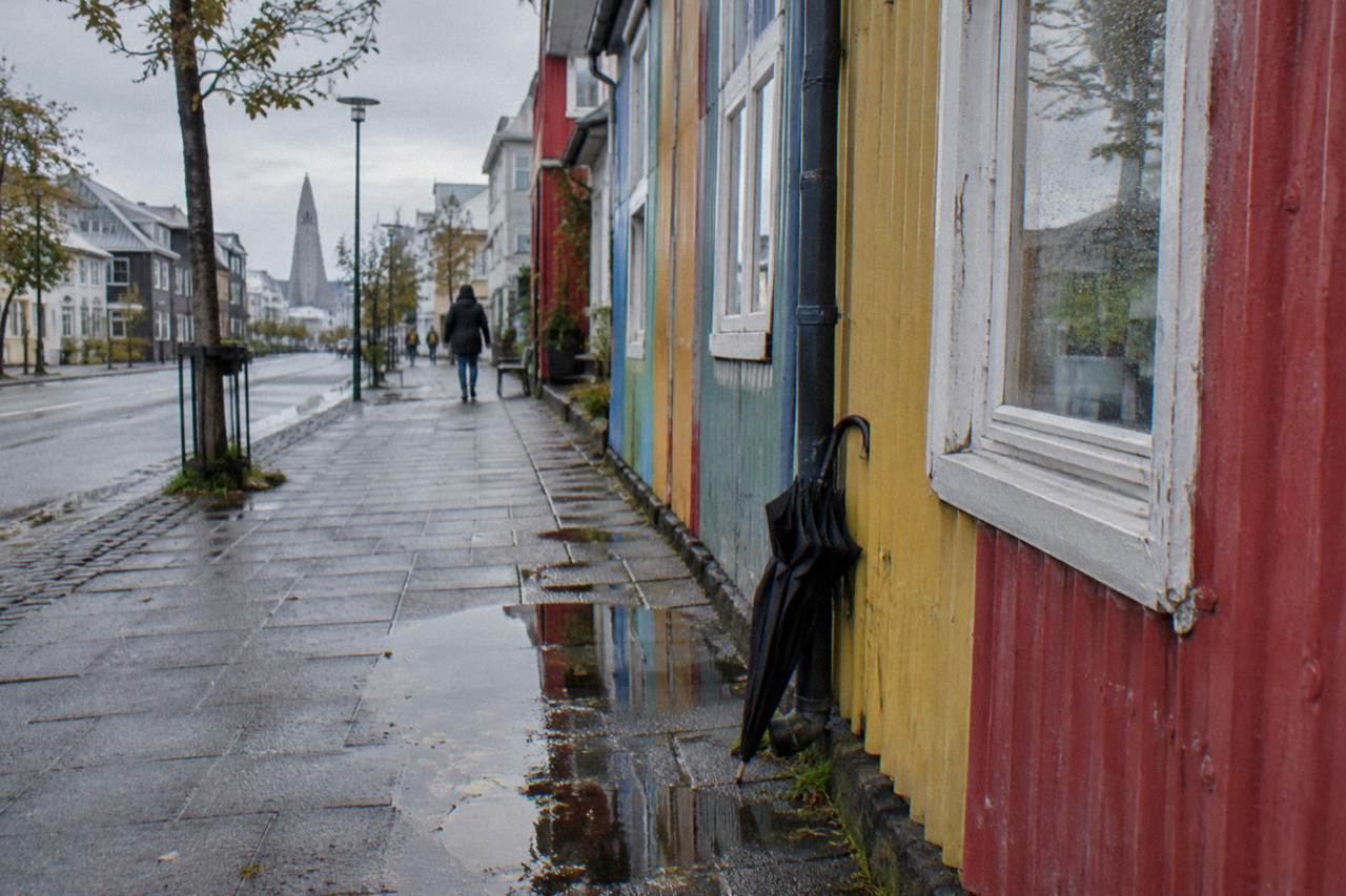 Rainy street in central Reykjavik with wet pavement and colourful corrugated iron houses