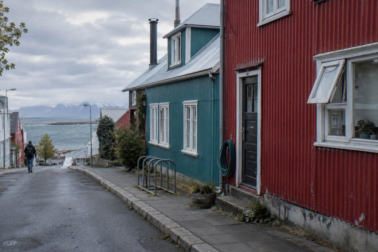 Colourful corrugated iron houses on a quiet Reykjavik street under an overcast sky