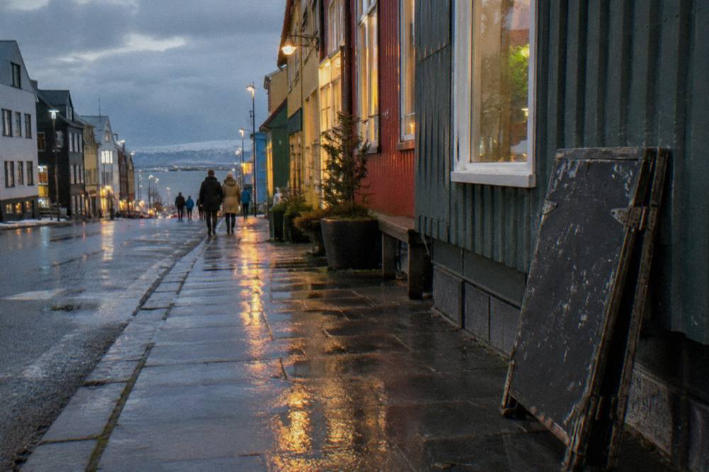 Laugavegur street in Reykjavik lit by shop signs and streetlights in the evening