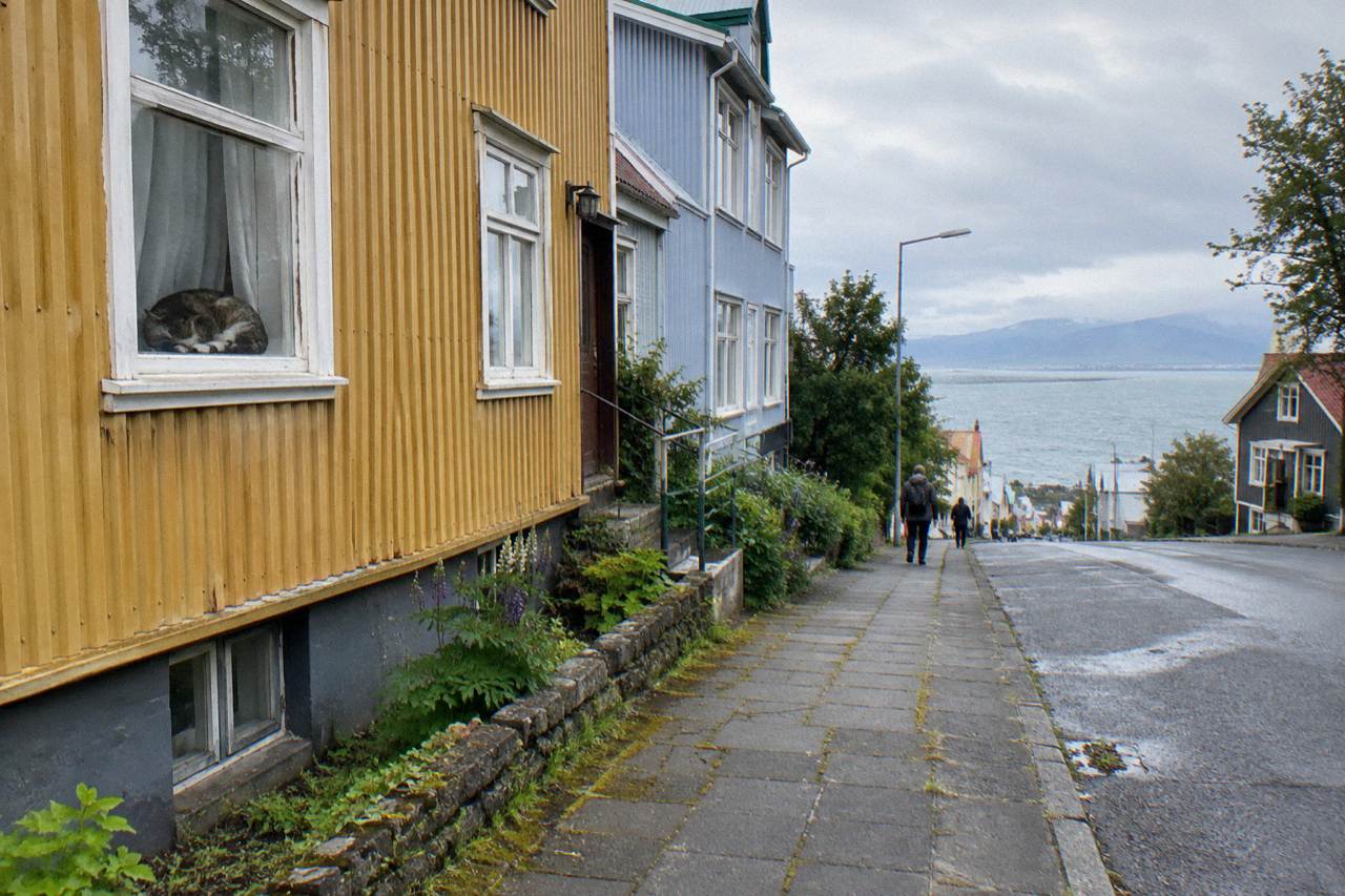 Colourful corrugated iron houses on a quiet Reykjavik street under an overcast sky