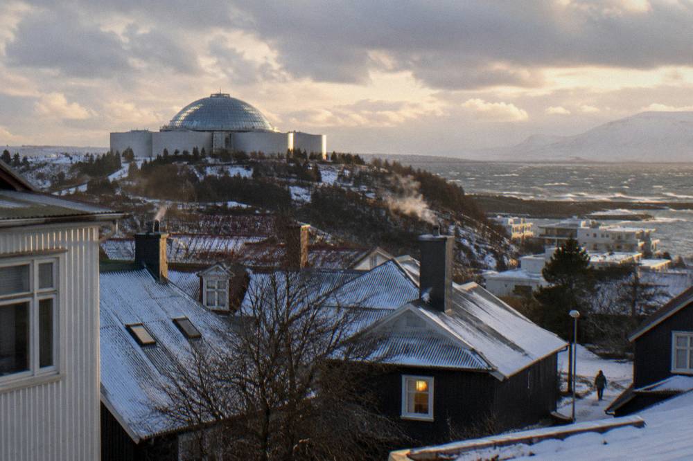 Reykjavik rooftops under low winter light with the church tower in the distance