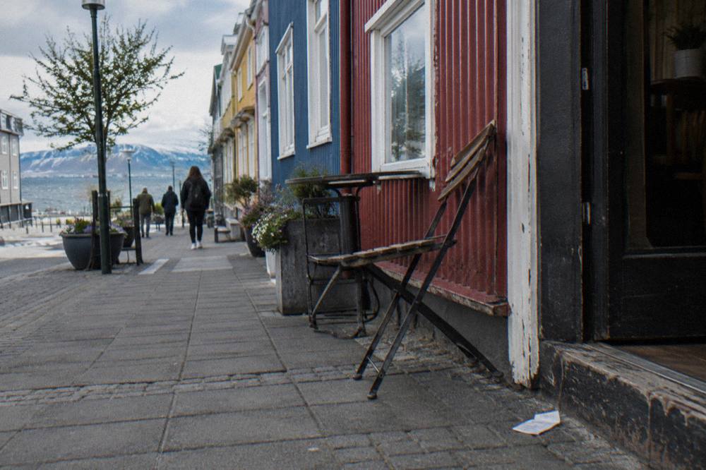Row of colourful painted corrugated iron buildings housing shops on a Reykjavik street