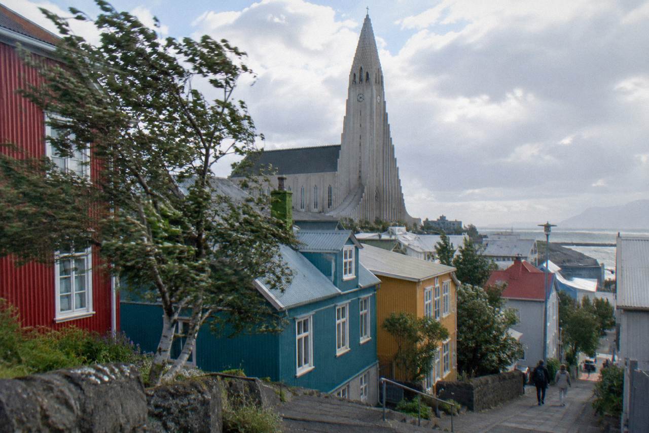 Colourful corrugated iron houses below a large hillside church in Reykjavik