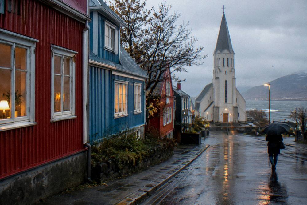 Reykjavik city street with colourful corrugated iron houses and wet pavement reflecting lights