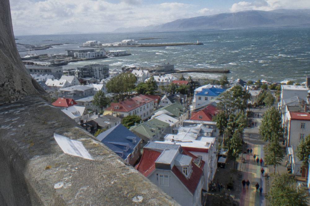 View over Reykjavik rooftops toward the old harbor from the Hallgrimskirkja tower observation deck
