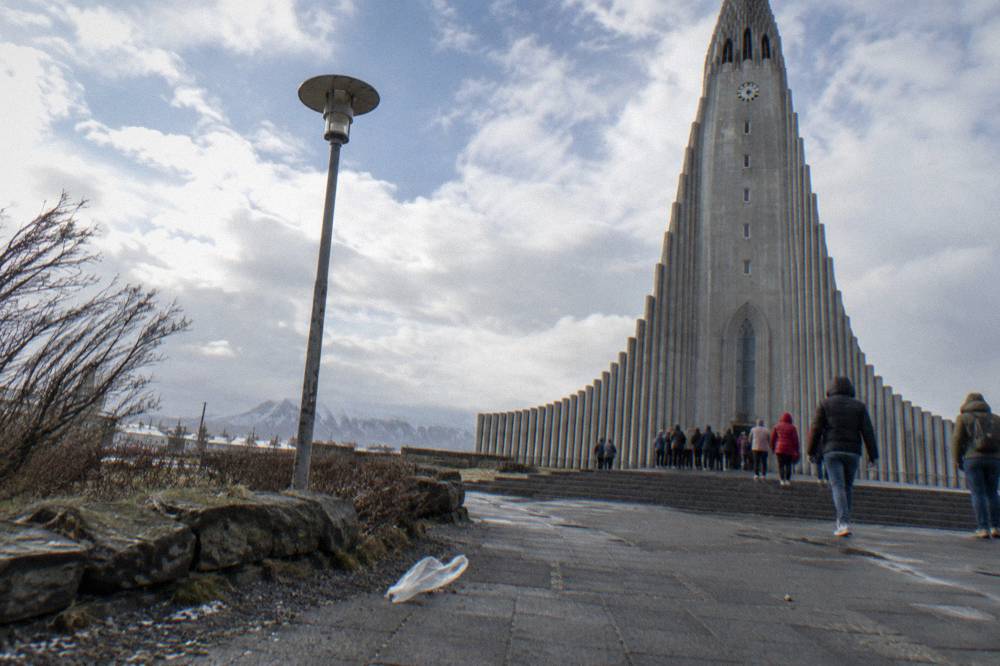 Visitors gathered outside the stepped concrete tower of Hallgrimskirkja church