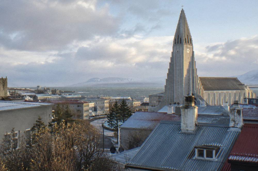 The stepped concrete tower of Hallgrimskirkja church rising above downtown rooftops