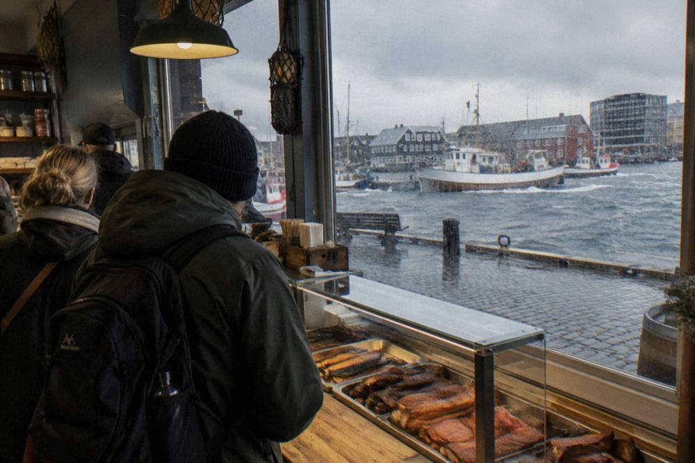 Food tour group standing at a counter inside an Icelandic delicatessen