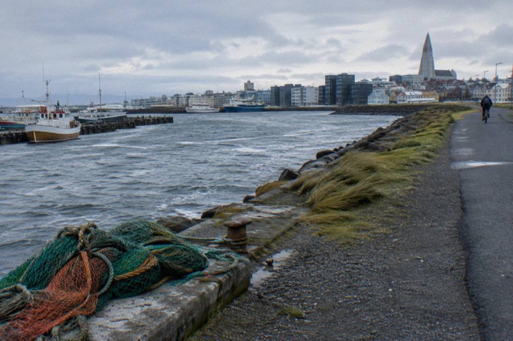 Cyclists on a waterside path beside the old harbour in Reykjavik