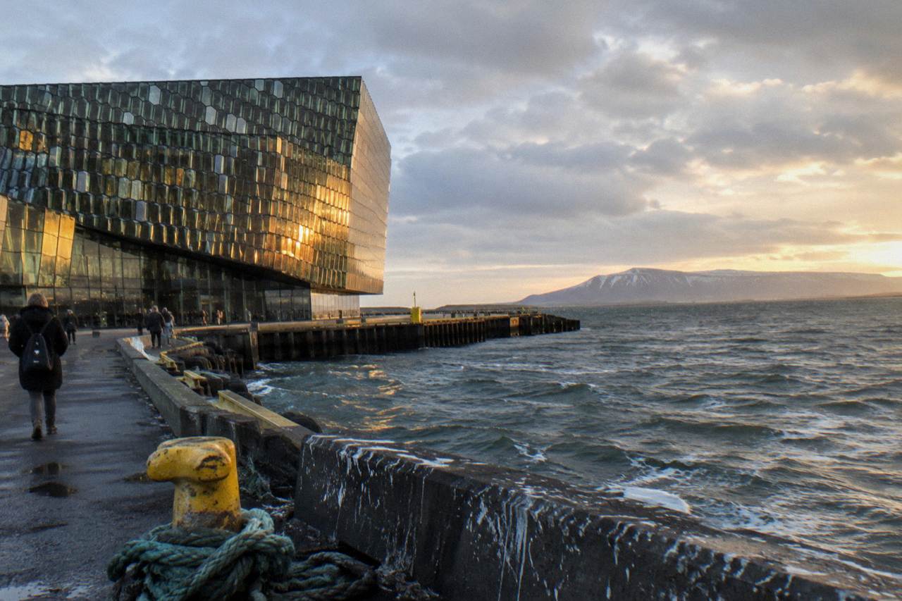 Harpa concert hall on the Reykjavik waterfront under a wide sky