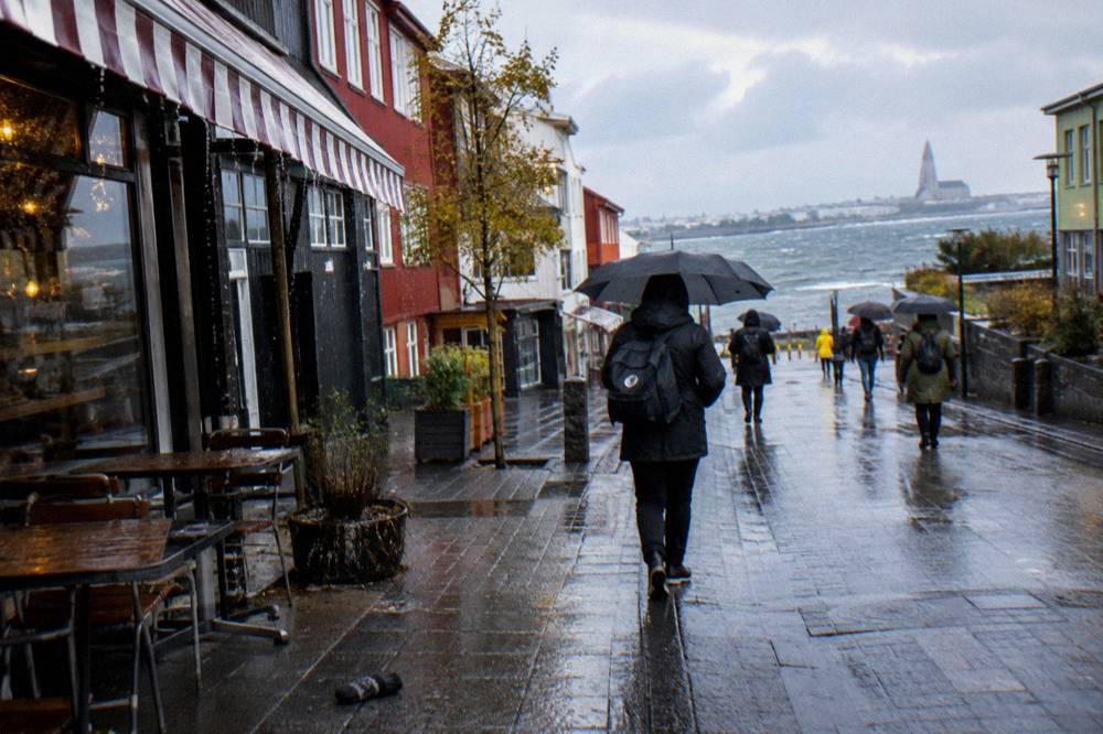 A wide flat pedestrian street with shops and cafes in downtown Reykjavik