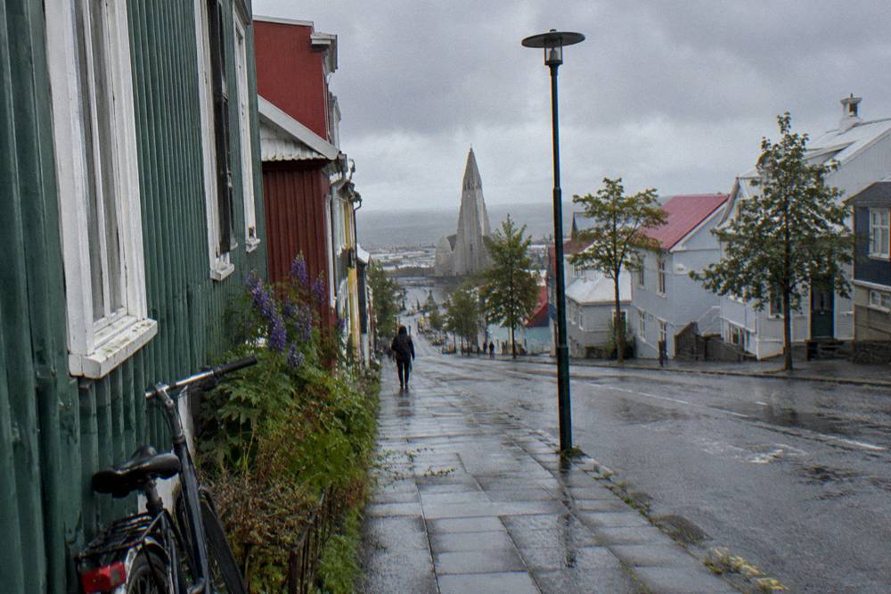 Rain-slicked Reykjavik street with reflections and grey sky