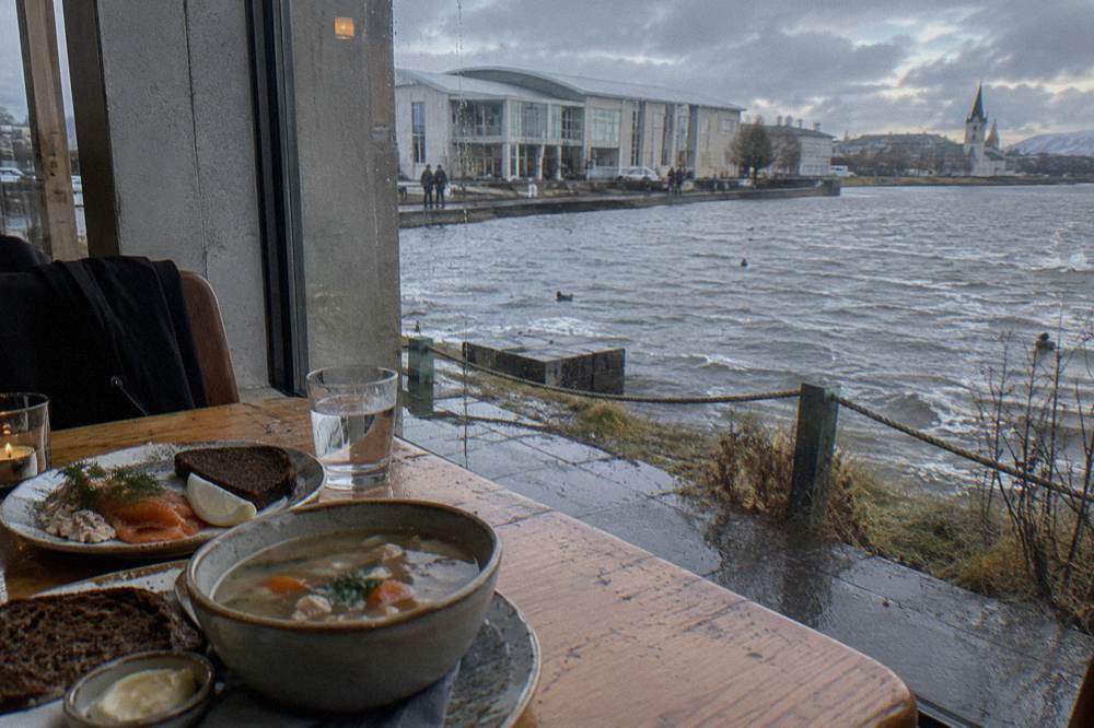 Table spread of Icelandic tasting dishes with rye bread, soup and smoked fish in a small restaurant