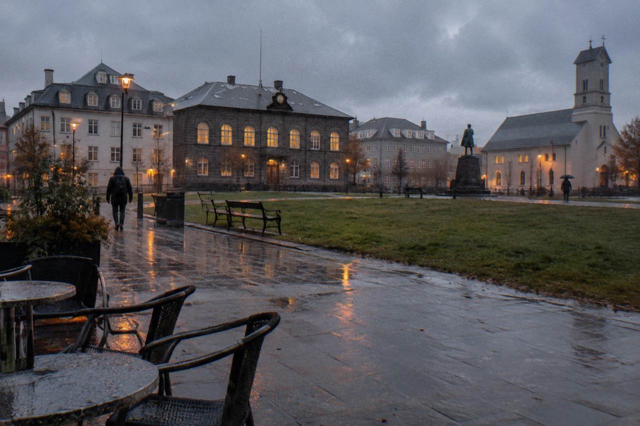 Rainy street in central Reykjavik with wet pavement reflecting building fronts