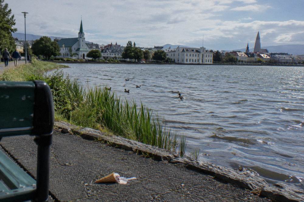 Tjörnin lake in central Reykjavik with the city hall at its edge and church towers beyond