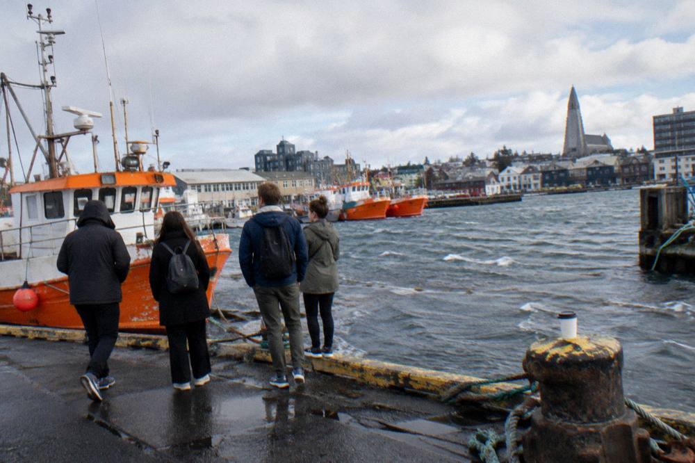 Visitors gathered at a Reykjavik harbour-side meeting point before the start of a guided walk