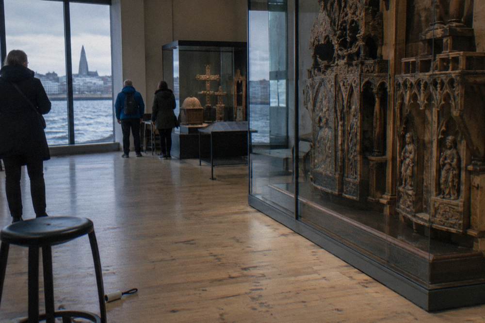 A modern Icelandic art museum interior with visitors looking at exhibits