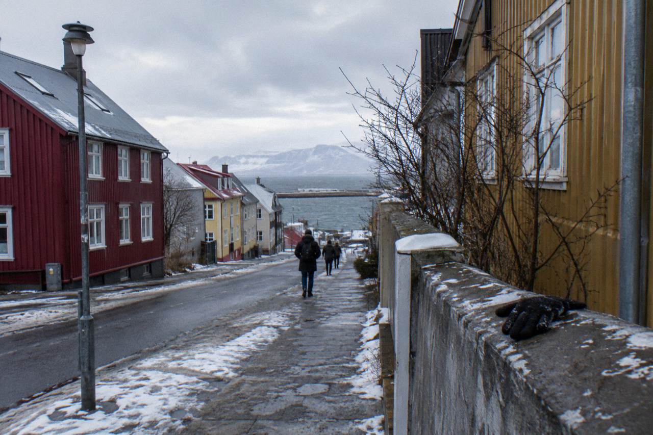 Colourful corrugated iron houses in Reykjavik under a low winter sky with snow patches on the street