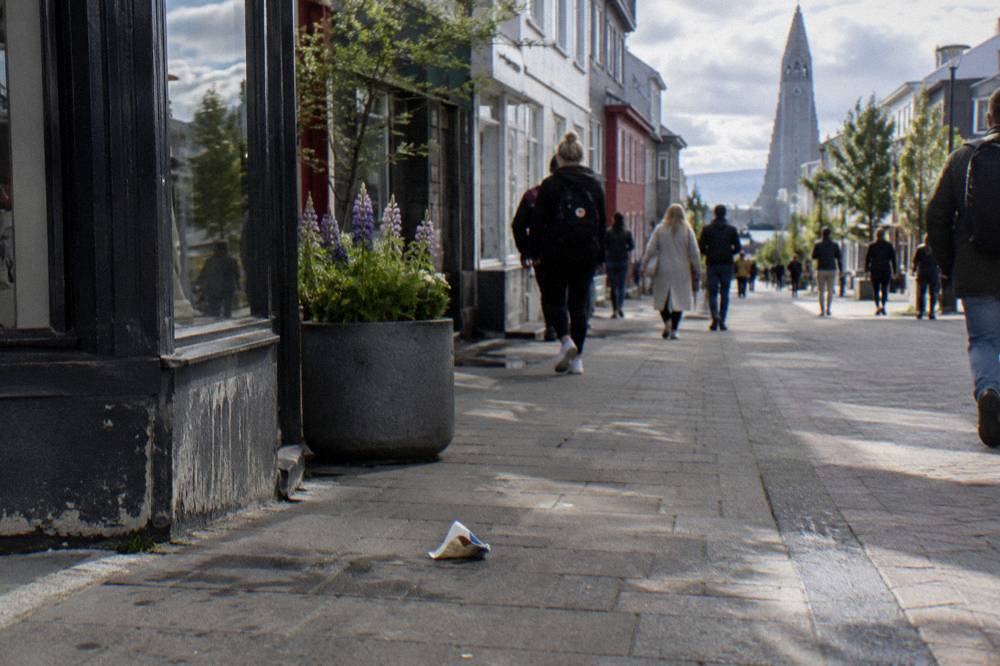 Shoppers walking along the main pedestrian shopping street in central Reykjavik