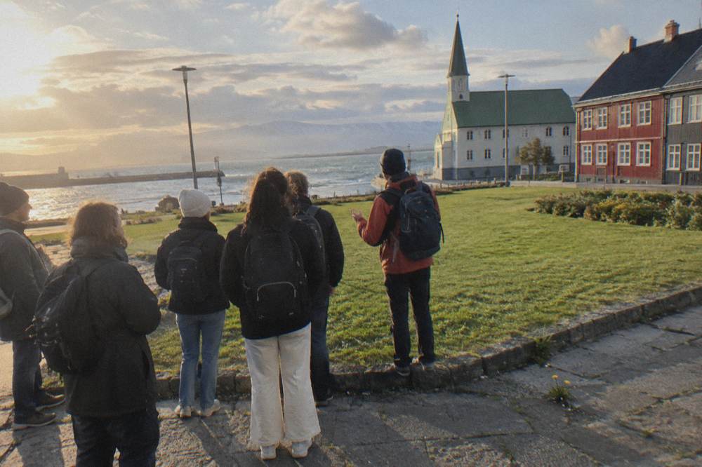 A local guide speaking to a small group gathered on a street corner in Reykjavik