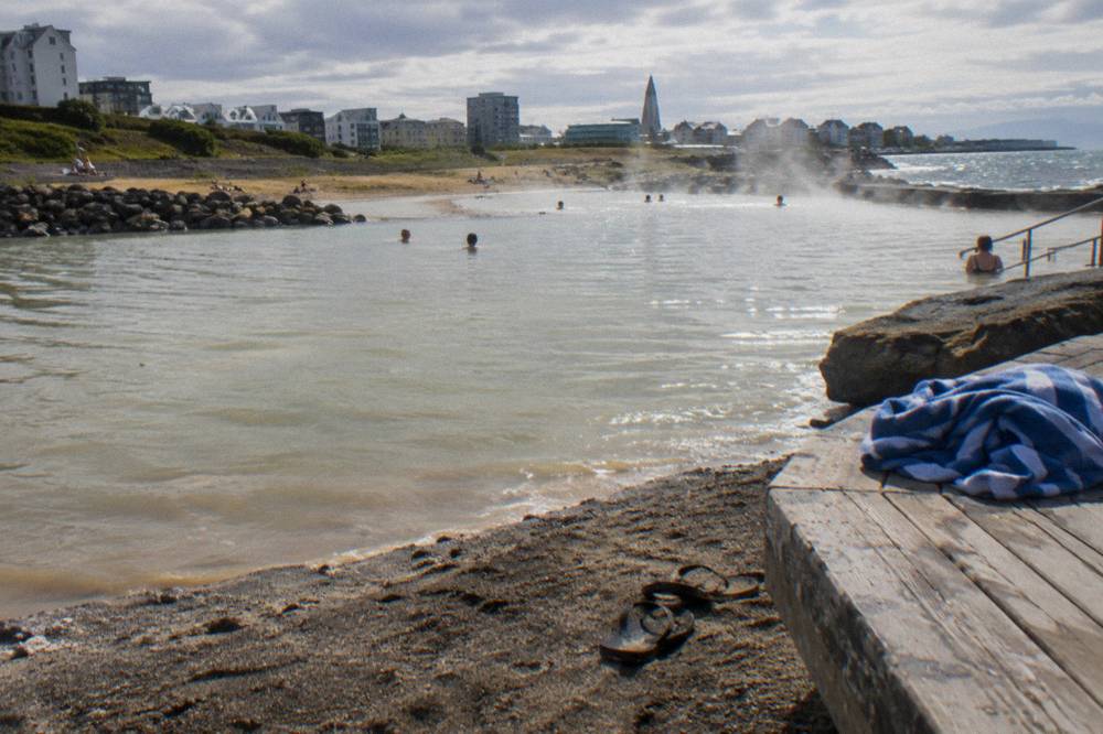 Geothermal outdoor pool with steam rising in a Reykjavik swimming complex
