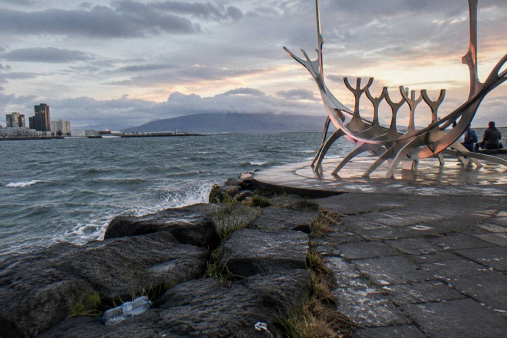 Steel sculpture of a dream boat on the waterfront promenade facing the sea at dusk