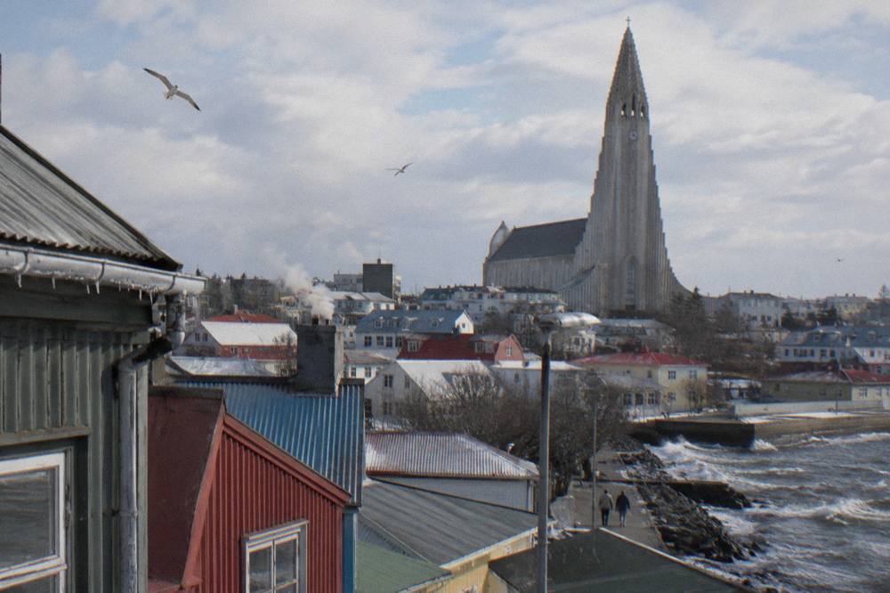 The stepped concrete tower of Hallgrimskirkja church rising above rooftops