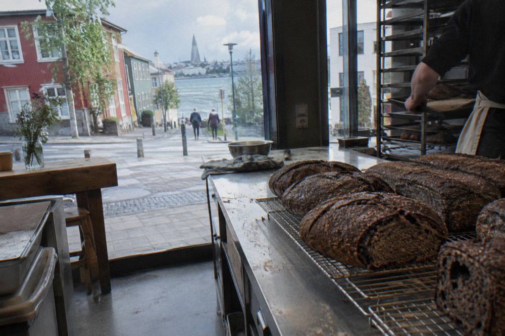 Freshly baked dark rye bread loaves cooling on a bakery counter