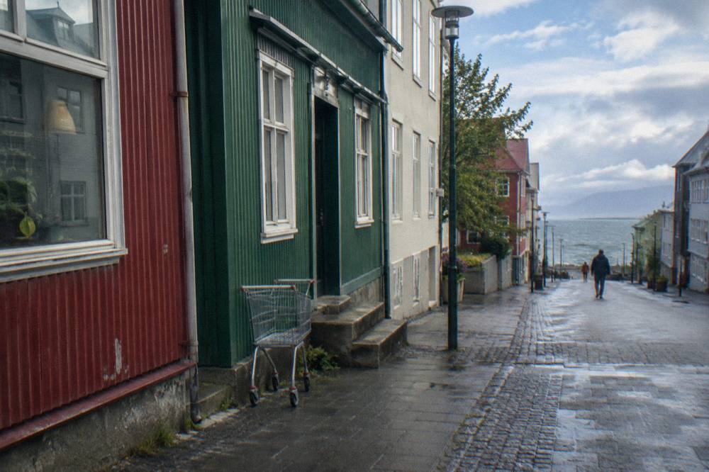 People-free view of Laugavegur shopping street with painted storefronts in daylight